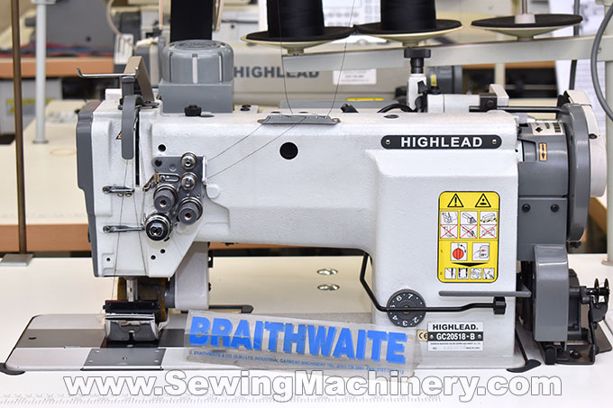 Twin needle sewing machine with puller feed