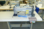 Needle feed sewing machine with puller feed
